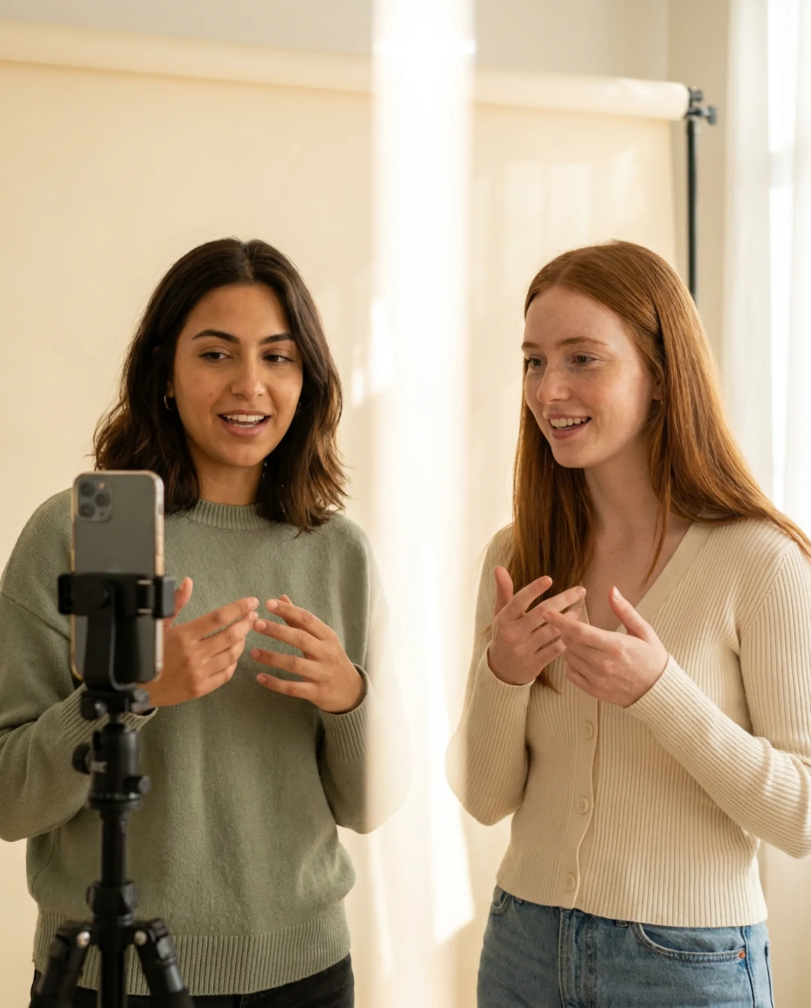 Two creators recording one video together on a single phone.